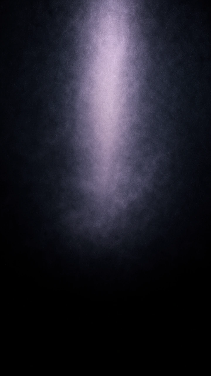 A tall column of pale lavender light standing in dark mist.
